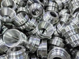 pile of shiny metal aerospace parts production - close-up with selective focus for full frame industrial background photo