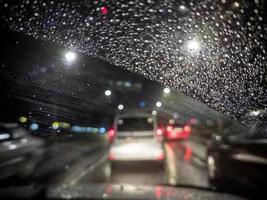 defocused photo of night driver view on city from right steering car