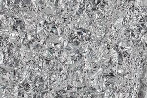 crumpled aluminium foil flat background and texture photo