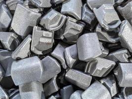 heap of gray steel forgings after shot blasting - close-up natural heavy industrial pattern with selective focus photo
