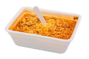 cooked instant noodle in rectangular cup and fork photo