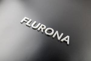 the word flurona laid with silver metal letters on gloss black background photo