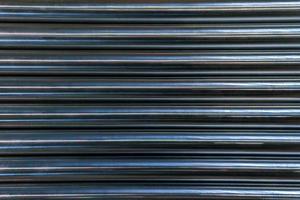 abstract industrial background of shiny cnc turned rods with flat lay horizontal parallel geometric pattern photo