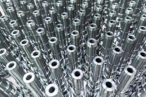 Shiny long steel parts full frame background, clean steel rods after fine cnc turning. photo