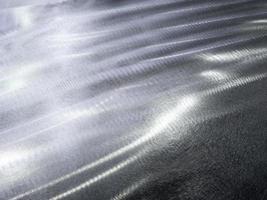 Close-up background of flat steel surface manually cleaned with a flap wheel angle grinder. photo