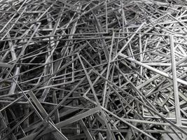 full frame abstract industrial background of stamping leftovers pile, close-up with selective focus photo