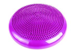Purple inflatable balance disk isoleated on white background, It is also known as a stability disc, wobble disc, and balance cushion. photo