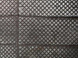 old cast iron factory floor tiles with checkered skid-proof pattern photo