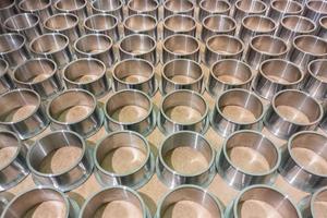 full frame batch array of shiny steel cylindrical sleeve parts with flange photo