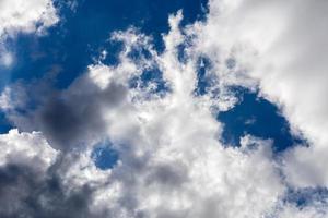 Regular spring clouds on blue sky at daylight in continental europe. Close shot wit telehoto lens and polarizing filter. photo