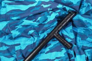 black rubber baton on blue urban russian riot police camouflage flat lay photo