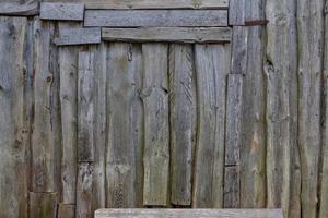 Fondo y textura de la superficie de la pared de tablones de madera desordenados grises foto