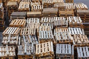 full frame background of used wooden pallet stacks - perspective view from above photo