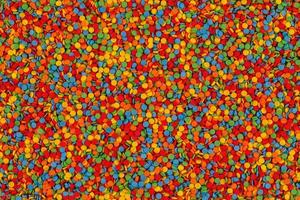 Rainbow sugar sprinkle dots, decoration for cake and seamless bakery texture. Confectionery multicolored decorative topping. photo