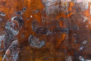 texture of old oxidated sheet of brass with colorful spots and some minor scratches photo