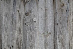 Fondo y textura de la superficie de la pared de tablones de madera seca gris foto