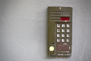 Old digital doorphone on gray flat surface photo