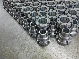 Shiny steel parts after cnc turning and milling, industrial background photo