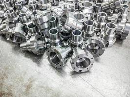 Shiny steel parts after cnc turning, drilling and machining on steel surface photo