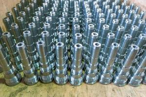 Shiny long steel parts background, clean steel rods after fine cnc turning. photo