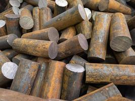 a pile of raw steel short rods cutted by saw- workpieces prepaired for forging, close-up with selective focus photo