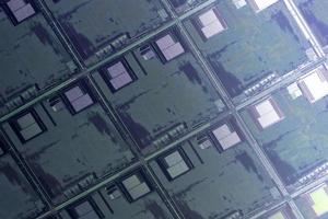 Silicon wafer with microchips used in electronics for the fabrication of integrated circuits. Full-frame high-tech macro background. photo