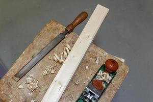 planer, file and wooden block on a stool photo