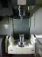 The five-axis Computer Numerical Control CNC machine waiting for stock change photo