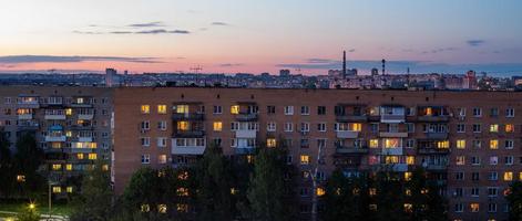 Windows, roofs and facade of an mass brick apartment building in Eastern Europe. Panoramic shot. photo