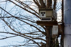 Speed radar camera detector mounted on the pole front closeup telephoto view photo
