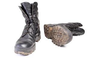 used dirty and dusty military black boots isolated on white back photo