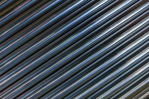 abstract industrial background of shiny cnc turned rods with flat lay diagonal geometric composition photo