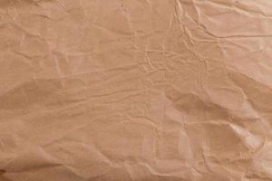 Ragged crumpled brown kraft paper texture and full frame background photo