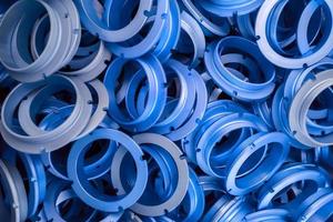 an abstract background of classic blue color coated metal ring parts photo