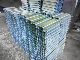 stacks of profile bent sheet metal parts on factory floor photo