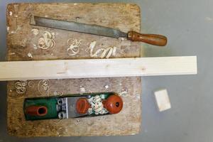 planer, file and wooden block on a stool photo