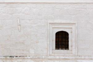 white stucco brick wall with window and torch place background photo