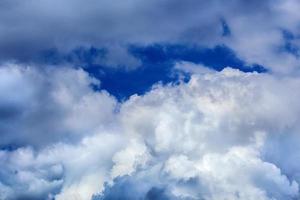 Regular spring clouds on blue sky at daylight in continental europe. Close shot wit telephoto lens and polarizing filter. photo