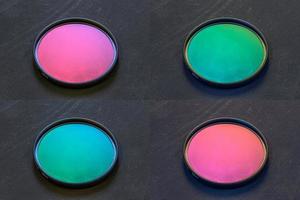 set of old rotary polarizing filter with stains on dark background photo