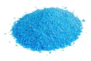 pile of blue copper sulfate granules - close-up isolated on white background photo