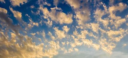 Early morning golden clouds on blue sky photo