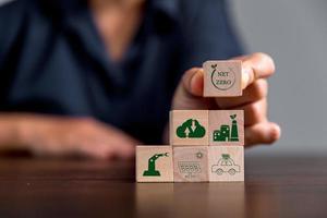 Companies are targeting net zero greenhouse gas emissions. Carbon credit concept.Tradable certificate to drive industry in direction of low emissions in efficiency cost. Wooden cubes with decrease CO2 photo