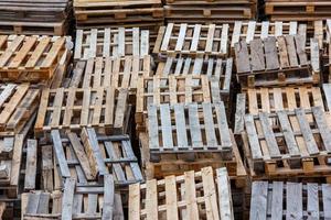 full frame background of used wooden pallet stacks - perspective view from above photo