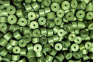 full frame batch of aluminium cylinder parts after anodizing with filling in green chromate solutions photo