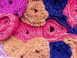 close-up full frame background of colored carpet rolls stack photo