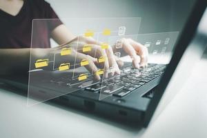 Officer using laptop manage files, Document Management System DMS, Online document database management, automated processes to manage system, ERP enterprise efficient, business technology. photo