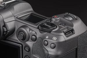 modern professional black digital photo camera controls - buttons, wheels, screens and joystick - close-up macro view