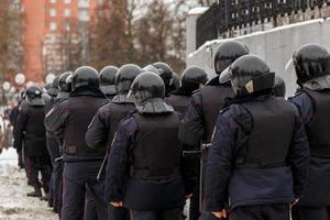 Public meeting in support of Navalny, police officers in black helmets photo