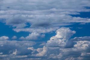 Regular spring clouds on blue sky at daylight in continental europe. Shot wit telehoto lens and polarizing filter. photo