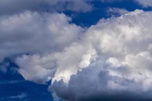 Regular spring clouds on blue sky at daylight in continental europe. Close shot wit telephoto lens and polarizing filter. photo